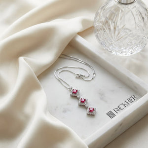 Pink Tourmaline Halo Pendant in 14K White Gold, on marble vanity tray with silk