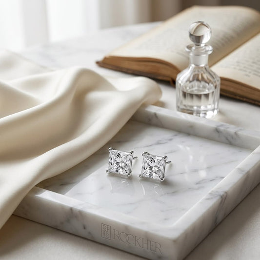 Natural Diamond Princess Cut Four Prong Stud Earrings in 14K White Gold, on marble vanity tray with silk