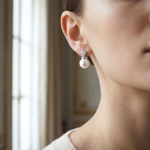 Pearl And Diamond Button Drop Earrings in 14K White Gold, worn close-up portrait