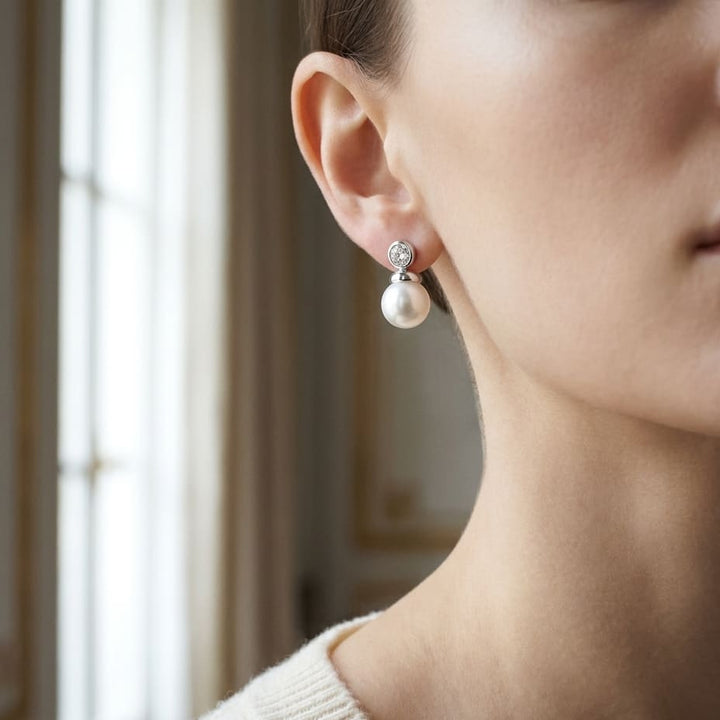 Pearl And Diamond Button Drop Earrings in 14K White Gold, worn close-up portrait