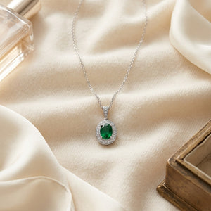 Emerald & Diamond Oval Halo Pendant 16 in Rolo Chain in 14K White Gold - flat lay