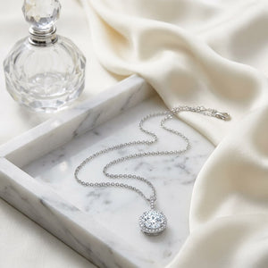 Natural Diamond Round Brilliant Halo Pendant in 14K White Gold, 1 ct. t.w., on marble vanity tray with silk
