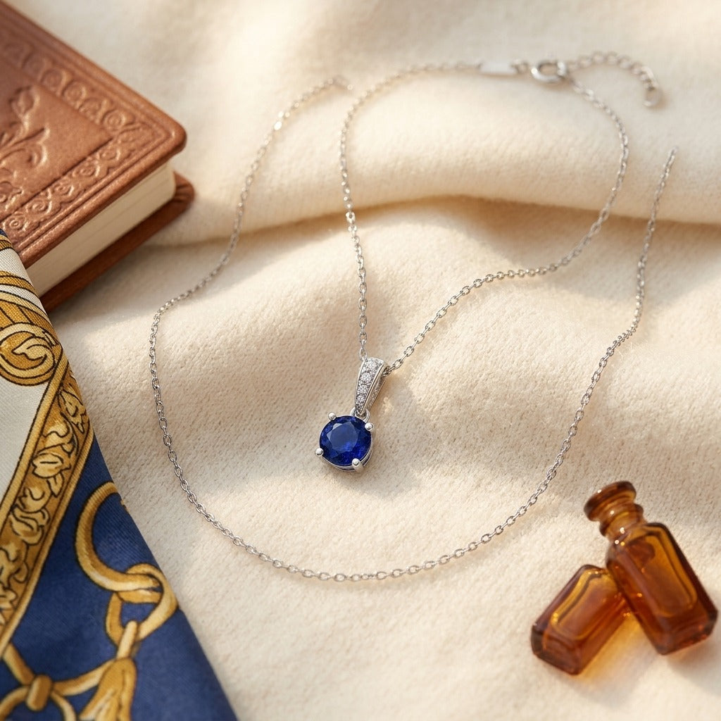 Sapphire Round Solitaire Pendant with Diamond Bail in 14K White Gold - flat lay