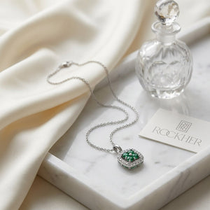 Emerald Pendant in 14K White Gold, on marble vanity tray with silk