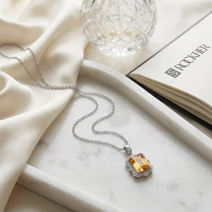 Citrine Emerald Cut Pendant in 14K White Gold, on marble vanity tray with silk