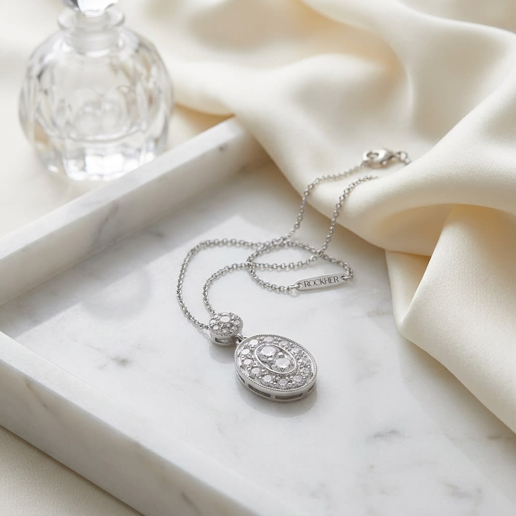 Natural Diamond Oval Halo Pendant in 14K White Gold, 1/3 ct. t.w., on marble vanity tray with silk