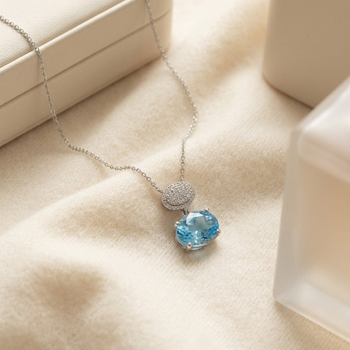 Blue Topaz Oval & Diamond 1/16ctw Pendant Set with Chain in 14K White Gold - flat lay