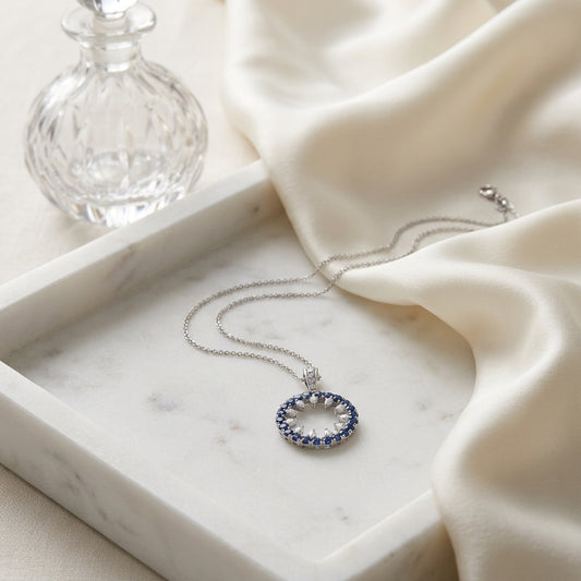 Sapphire and Diamond Circle Pendant in 14k White Gold 0.52ctw, on marble vanity tray with silk