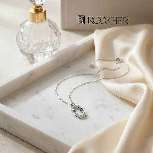 Sapphire and Diamond Flexible Paperclip Pendant in 14k White Gold 0.21ctw, on marble vanity tray with silk
