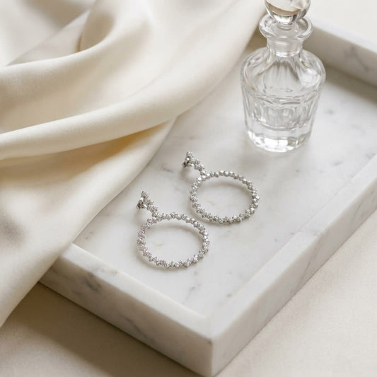 Scattered Diamonds Circle Earrings in 14k White Gold 3.38ctw, on marble vanity tray with silk