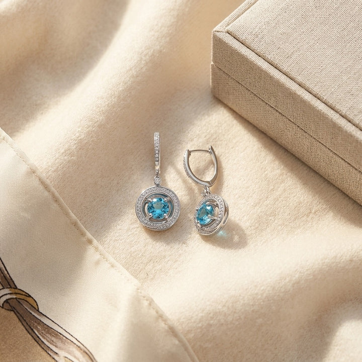 Blue Topaz & Diamond Swirl Dangling Earrings in 14K White Gold - flat lay