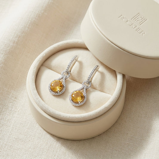 Citrine And Diamond Round Doorknocker Earrings in 14K White Gold, in navy velvet jewelry box