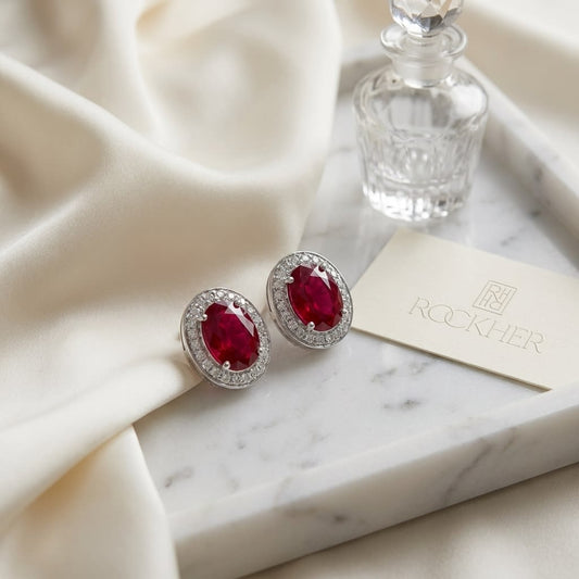 Ruby Oval Stud Earrings in 14K White Gold, on marble vanity tray with silk