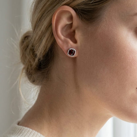 Garnet Cushion Stud Earrings in 14K White Gold, worn close-up portrait
