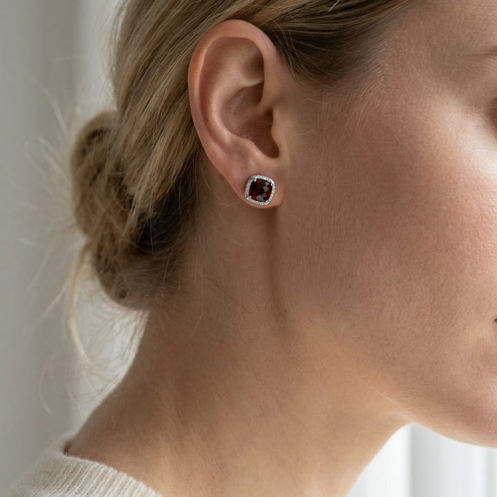 Garnet Cushion Stud Earrings in 14K White Gold, worn close-up portrait