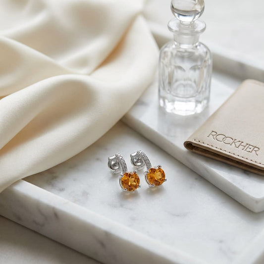 Citrine And Diamond Drop Earrings in 14K White Gold, on marble vanity tray with silk