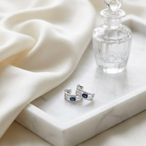 Sapphire Round Brilliant Stud Earrings in 14K White Gold, on marble vanity tray with silk