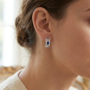 Sapphire Round Brilliant Stud Earrings in 14K White Gold, worn close-up portrait