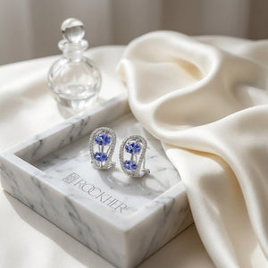 Tanzanite Round Brilliant Stud Earrings in 14K White Gold, on marble vanity tray with silk