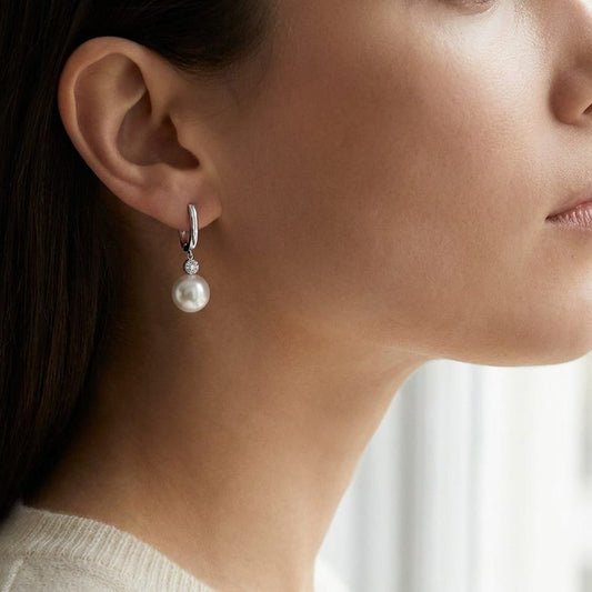 Pearl And Diamond Pave Disk Dangle Earring in 14K White Gold, worn close-up portrait