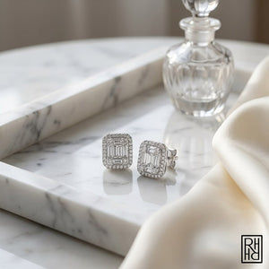Emerald Round Brilliant Stud Earrings in 14K White Gold, on marble vanity tray with silk