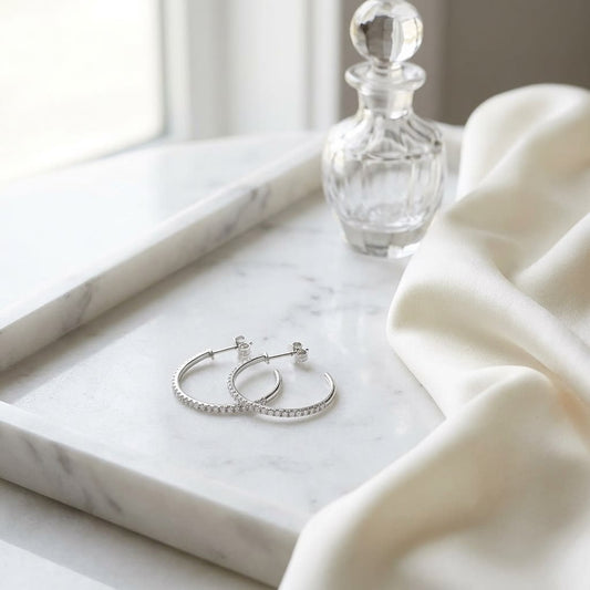 Diamond Pave J-hoop Earrings With Push Backs in 14K White Gold, on marble vanity tray with silk