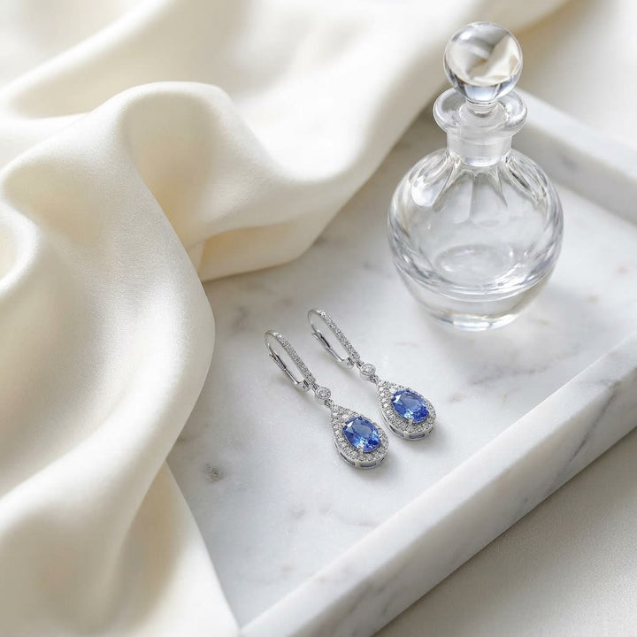 Tanzanite And Diamond Pave Drop Earrings in 14K White Gold, on marble vanity tray with silk