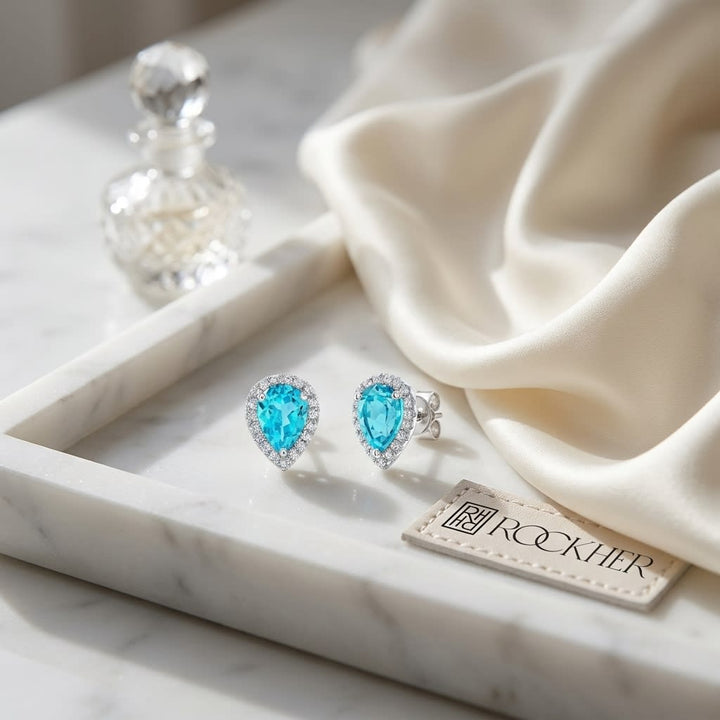 Swiss Blue Topaz Round Brilliant Stud Earrings in 14K White Gold, on marble vanity tray with silk