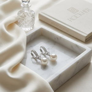 White Pearl And Diamond Dangle Earrings With Clover Top & Miillgrain Detail (8.0-8.5mm) (si), on marble vanity tray with silk