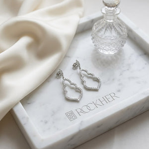 Diamond Open Damask Dangle Earrings in 14K White Gold, on marble vanity tray with silk