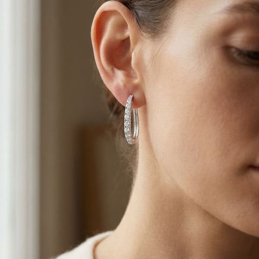 Diamond Pave Single Row Outside Oval Hoop Earrings in 14K White Gold, worn close-up portrait