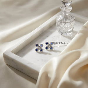 Sapphire and Diamond Clover Floral Stud Earrings in 14k White Gold 0.08ctw, on marble vanity tray with silk