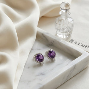 Amethyst and Diamond Ripple Edge Halo Stud Earrings in 14k White Gold 0.19ctw, on marble vanity tray with silk