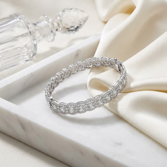 Diamond Scallop Edge Bangle in 14K White Gold, on marble vanity tray with silk