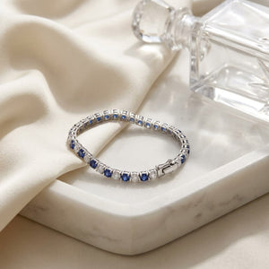 Alternating Sapphire and Diamond Bolo Bracelet in 14k White Gold 2.13ctw, on marble vanity tray with silk