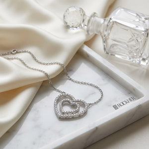Diamond Double Heart Frame Necklace in 14K White Gold, on marble vanity tray with silk