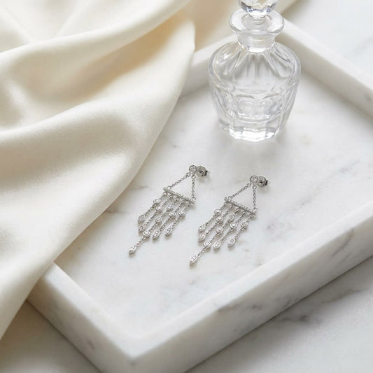 Diamond Wind Chime Dangle Necklace in 14K White Gold, on marble vanity tray with silk