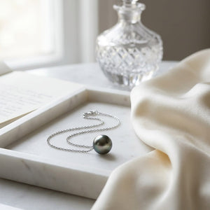 Black South Sea Pearl Floating Necklace in 14K White Gold, on marble vanity tray with silk