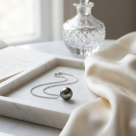 Black South Sea Pearl Floating Necklace in 14K White Gold, on marble vanity tray with silk