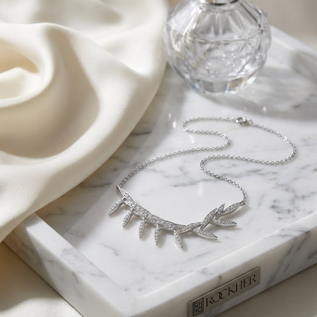 Diamond Pave Floating Laurel Leaves Necklace in 14K White Gold, on marble vanity tray with silk