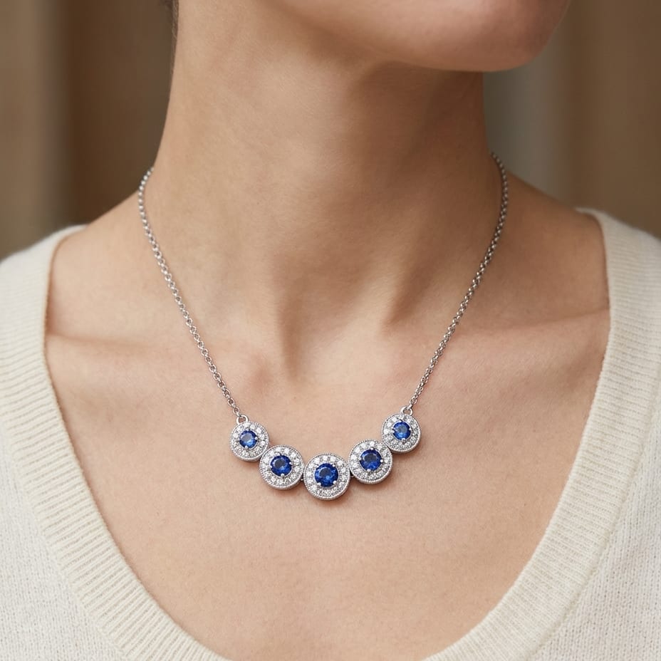 Sapphire And Diamond Graduated Curved Necklace in 14K White Gold, worn close-up portrait