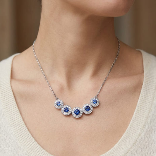 Sapphire And Diamond Graduated Curved Necklace in 14K White Gold, worn close-up portrait