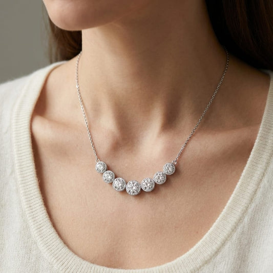Diamond 7-stone Round Bezel Graduated Necklace With Millgrained Edging in 14K White Gold, worn close-up portrait