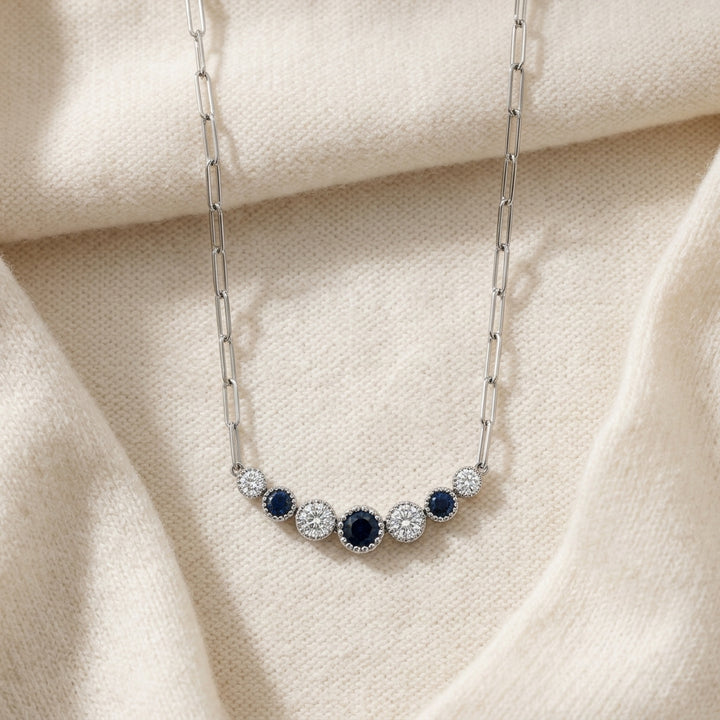 Sapphire & Diamond Graduated 7-Stone Necklace with Millgrained Edging in 14K White Gold - flat lay