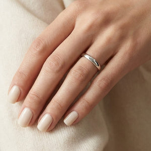 2.5mm Slightly Domed Traditional Oval Wedding Band in 14K White Gold, worn on hand, close-up