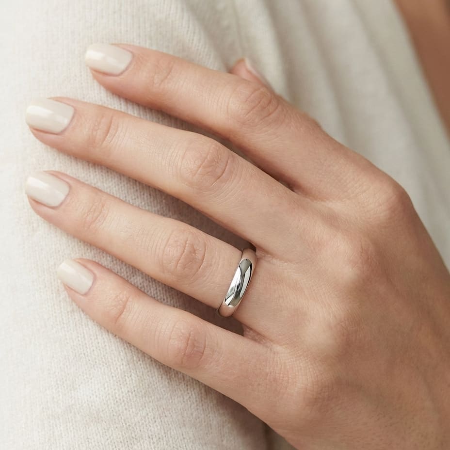 4mm Slightly Domed Traditional Oval Wedding Band in 14K White Gold, worn on hand, close-up