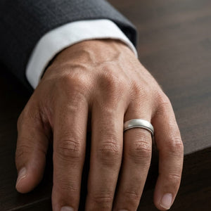 5mm Slightly Domed Traditional Oval Milgrain Wedding Band in 14K White Gold, worn on hand, masculine close-up