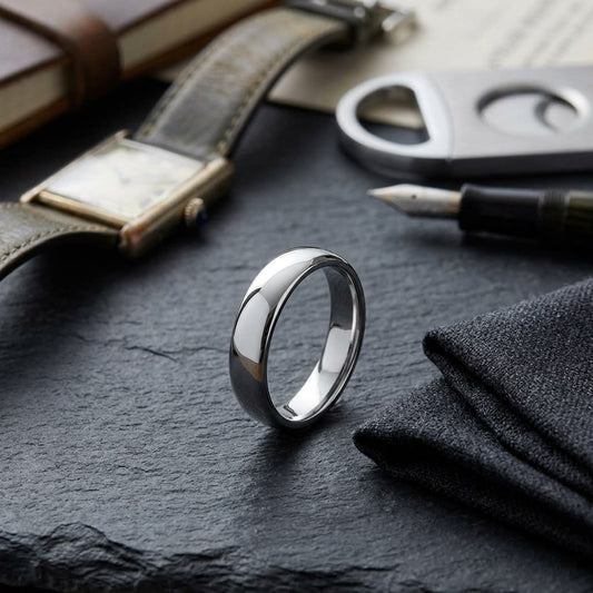 4.5mm Flat Comfort-Fit Wedding Band in 14K White Gold, on walnut surface with pocket square
