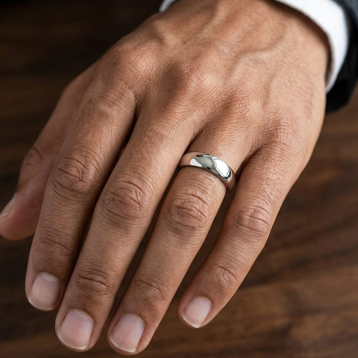 5.5mm Deluxe Comfort-Fit Wedding Band in 14K White Gold, worn on hand, masculine close-up