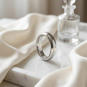 4mm High Dome Comfort-Fit Wedding Band in 14K White Gold, on marble vanity tray with silk